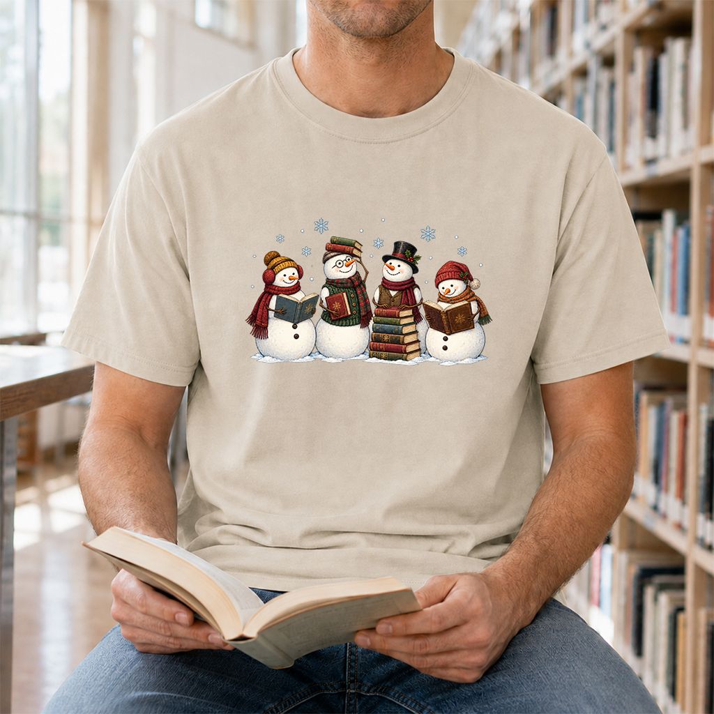 Four Snowmen Reading Printed T-Shirt | Christmas Book Lover Gift Sand