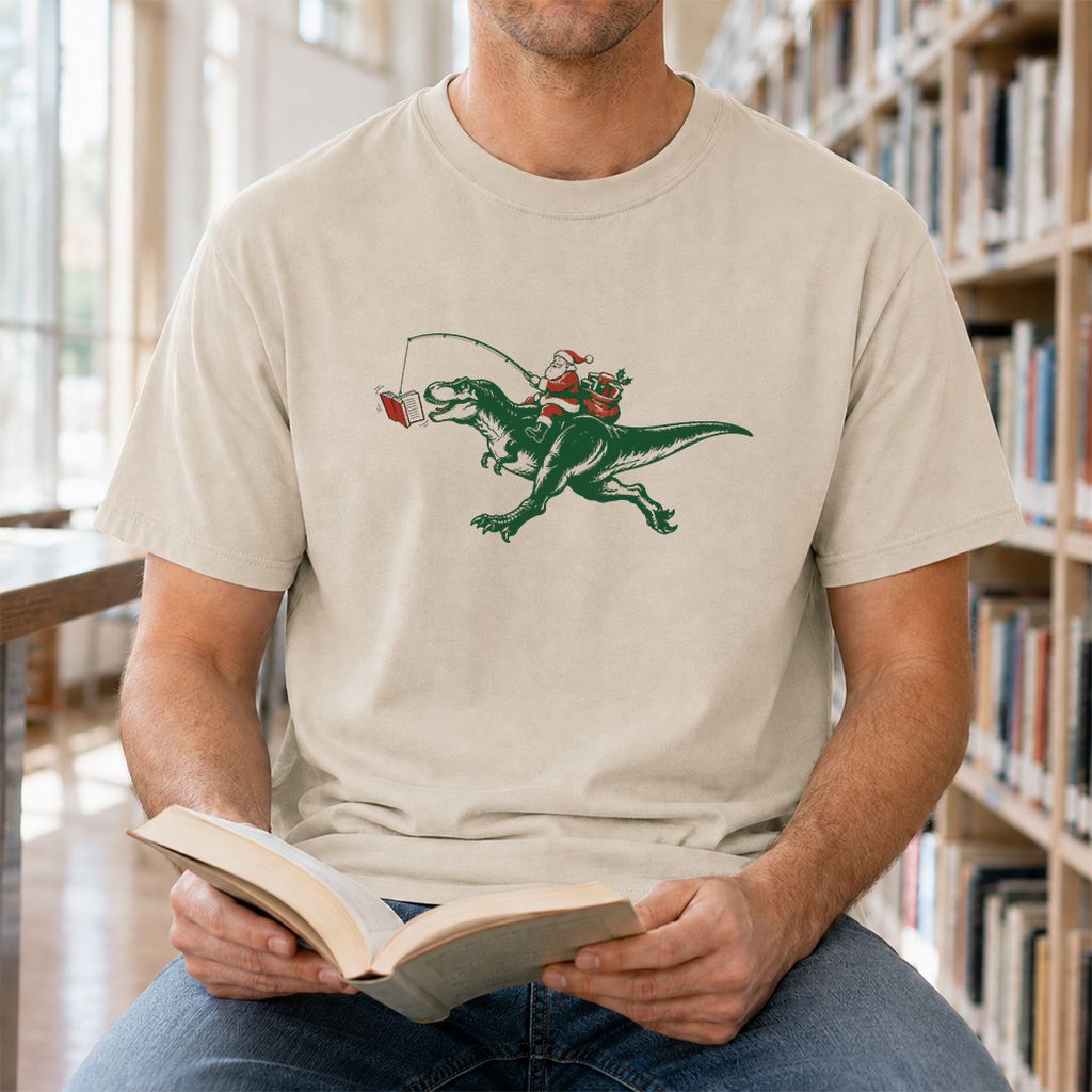 Santa Riding T-Rex Printed T-Shirt | Christmas Reader Gift Sand