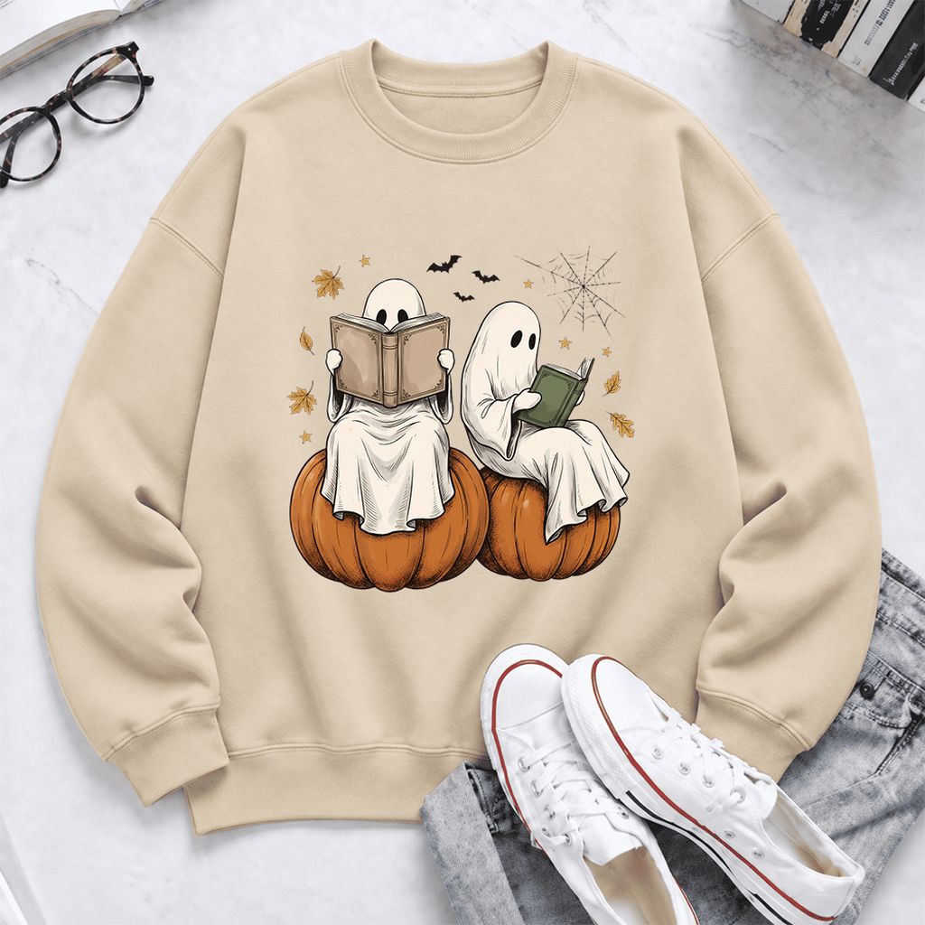 Small Ghosts Reading on Pumpkins Softstyle Sweatshirt | Spooky Book Lover Gift Sand