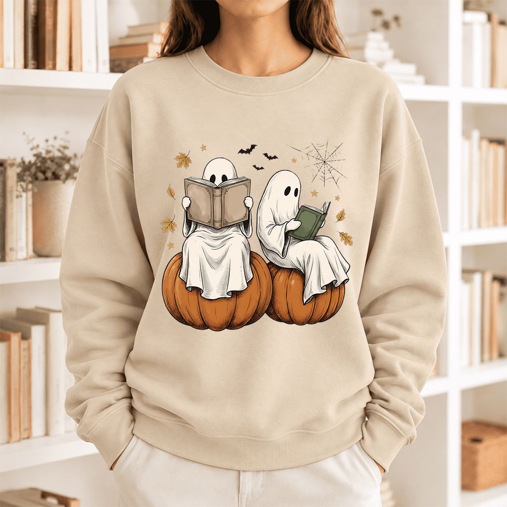 Small Ghosts Reading on Pumpkins Softstyle Sweatshirt | Spooky Book Lover Gift Sand