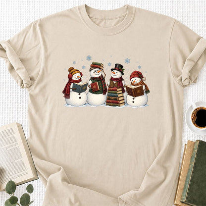 Four Snowmen Reading Printed T-Shirt | Christmas Book Lover Gift Sand