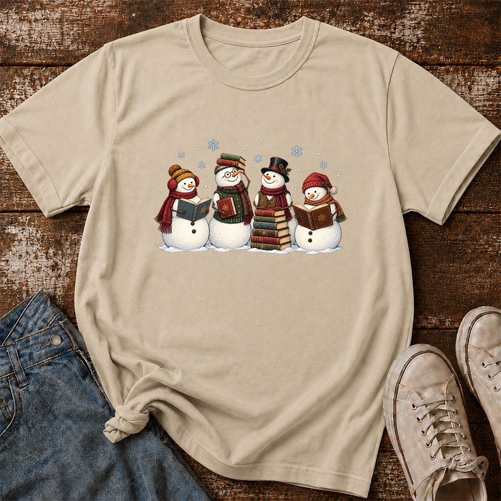 Four Snowmen Reading Printed T-Shirt | Christmas Book Lover Gift Sand