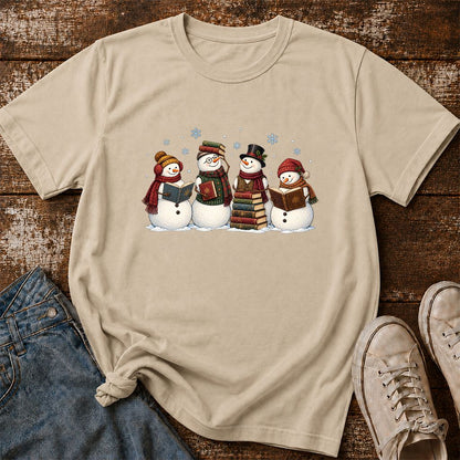 Four Snowmen Reading Printed T-Shirt | Christmas Book Lover Gift Sand