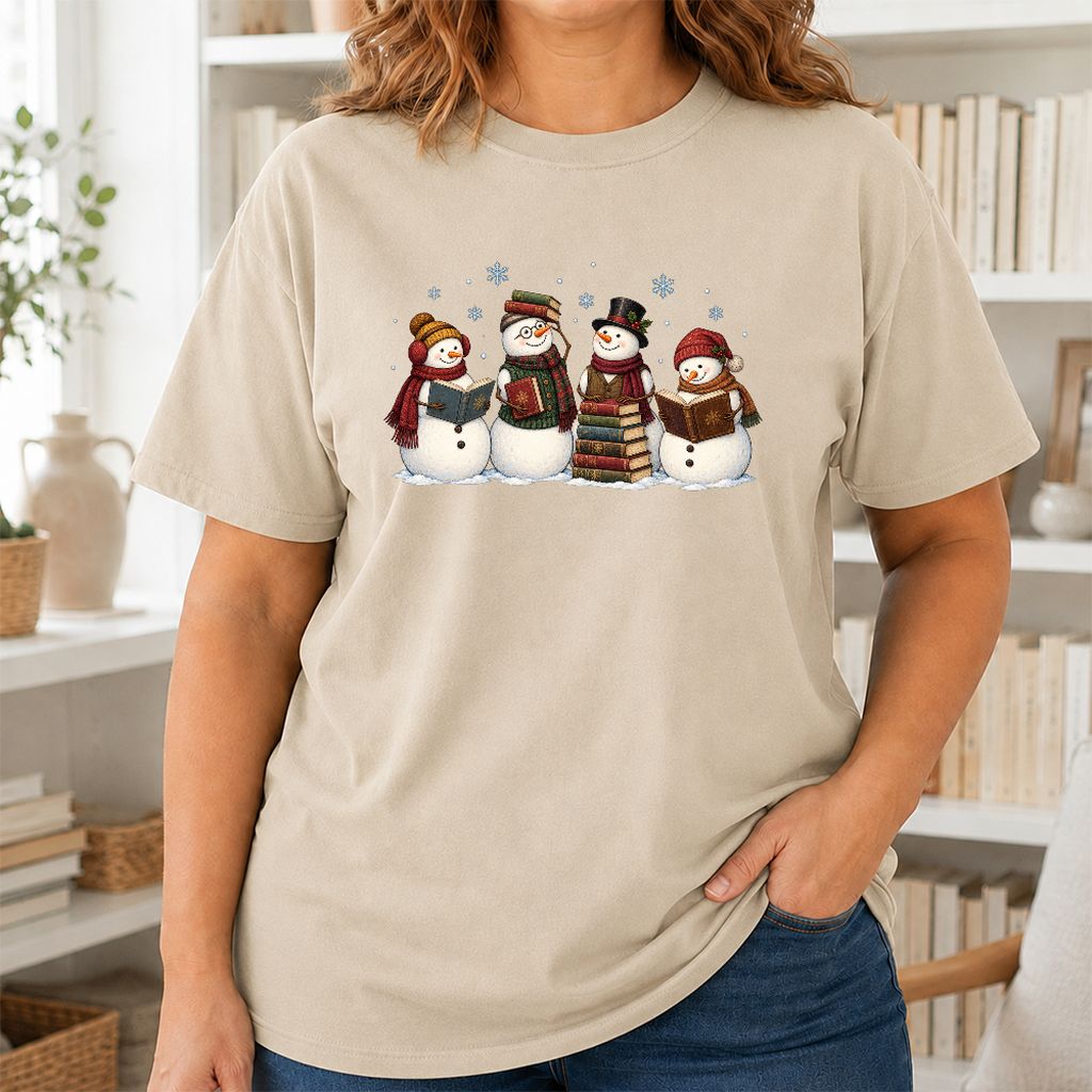Four Snowmen Reading Printed T-Shirt | Christmas Book Lover Gift Sand