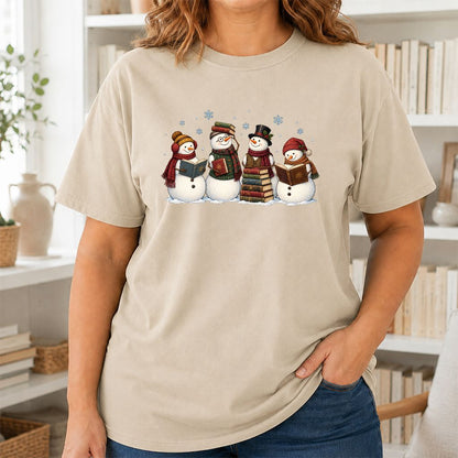 Four Snowmen Reading Printed T-Shirt | Christmas Book Lover Gift Sand