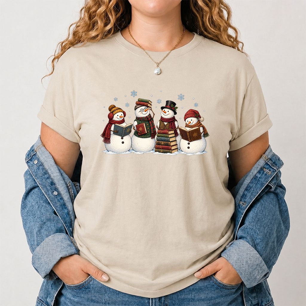 Four Snowmen Reading Printed T-Shirt | Christmas Book Lover Gift Sand