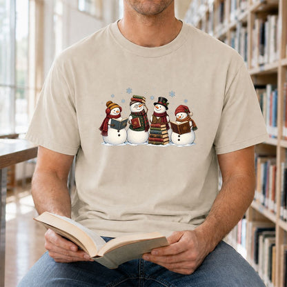 Four Snowmen Reading Printed T-Shirt | Christmas Book Lover Gift Sand
