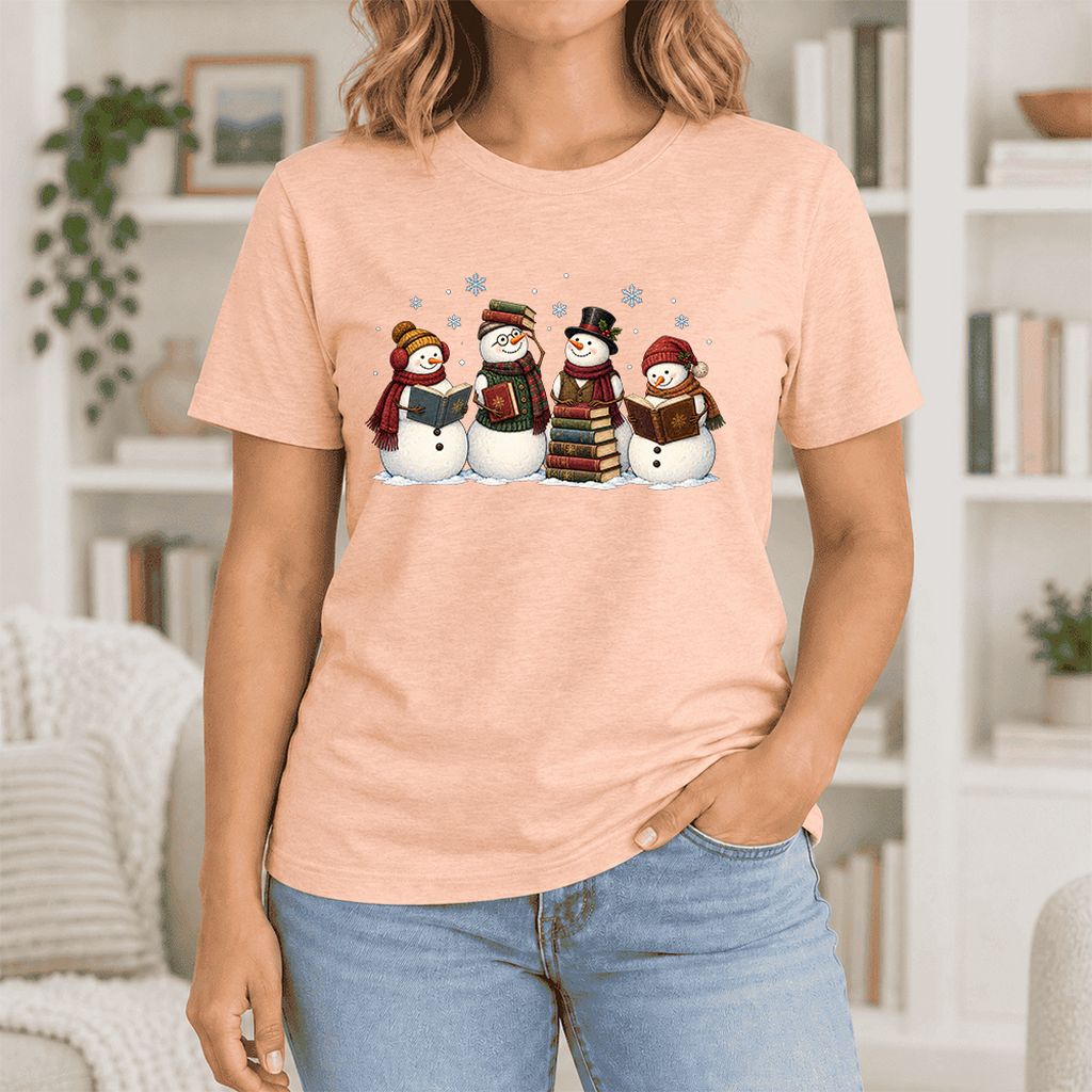 Four Snowmen Cozy Reading Ultra-Soft Cotton T-Shirt | Christmas Reader Gift Heather Peach
