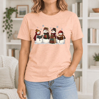 Four Snowmen Cozy Reading Ultra-Soft Cotton T-Shirt | Christmas Reader Gift Heather Peach