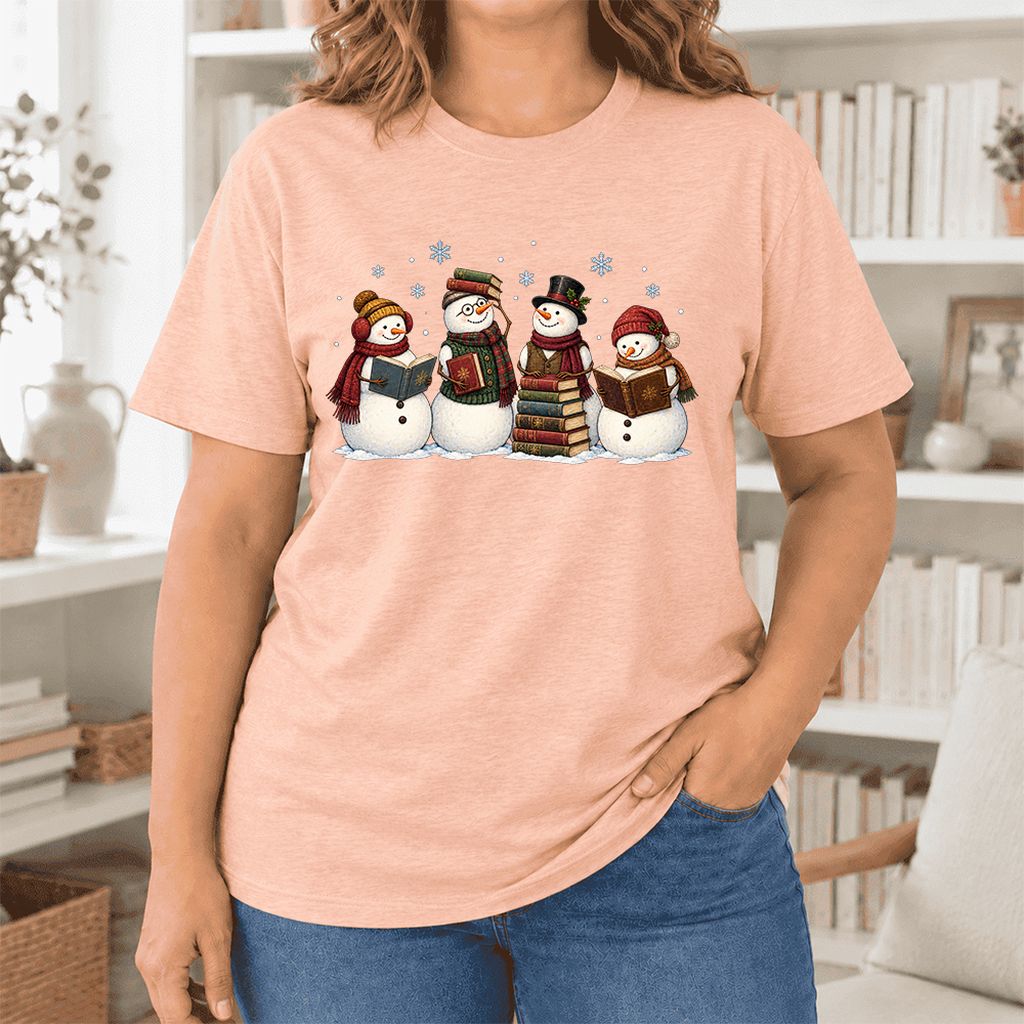 Four Snowmen Cozy Reading Ultra-Soft Cotton T-Shirt | Christmas Reader Gift Heather Peach