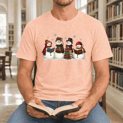 Four Snowmen Cozy Reading Ultra-Soft Cotton T-Shirt | Christmas Reader Gift Heather Peach