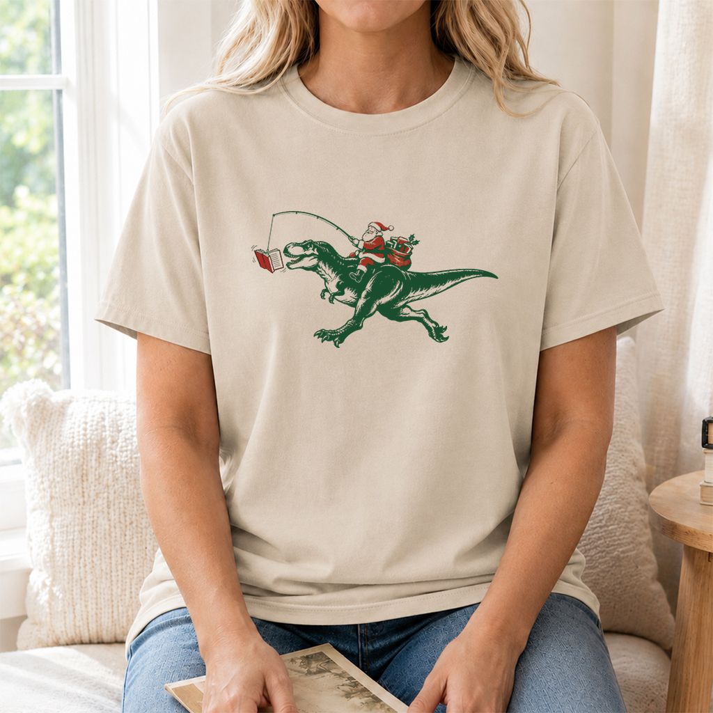 Santa Riding T-Rex Printed T-Shirt | Christmas Reader Gift Sand