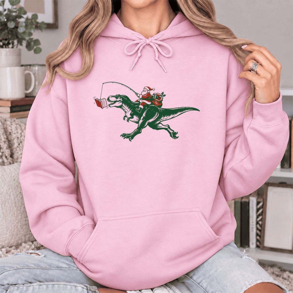 Santa Riding T-Rex Softstyle Hoodie | Christmas Reader Gift Light Pink