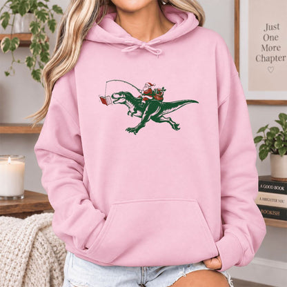 Santa Riding T-Rex Softstyle Hoodie | Christmas Reader Gift Light Pink