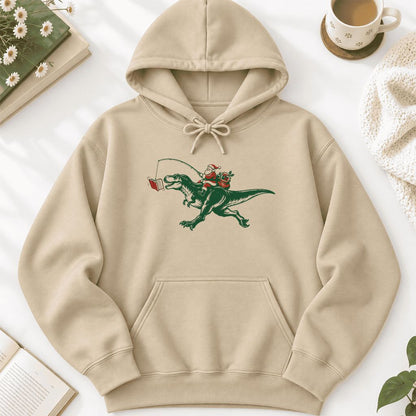 Santa Riding T-Rex Softstyle Hoodie | Christmas Reader Gift Sand