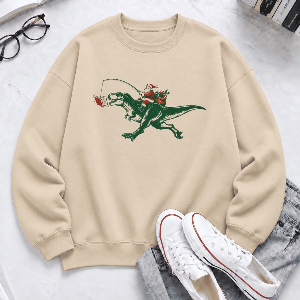Santa Riding T-Rex Softstyle Sweatshirt | Christmas Reader Gift Sand