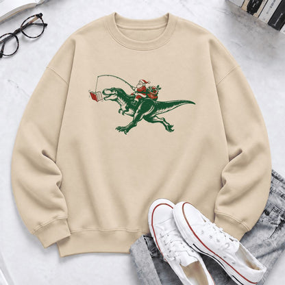 Santa Riding T-Rex Softstyle Sweatshirt | Christmas Reader Gift Sand