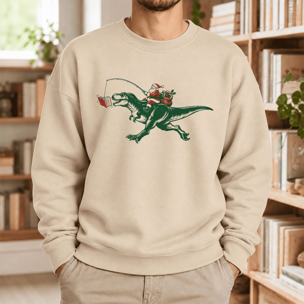 Santa Riding T-Rex Softstyle Sweatshirt | Christmas Reader Gift Sand