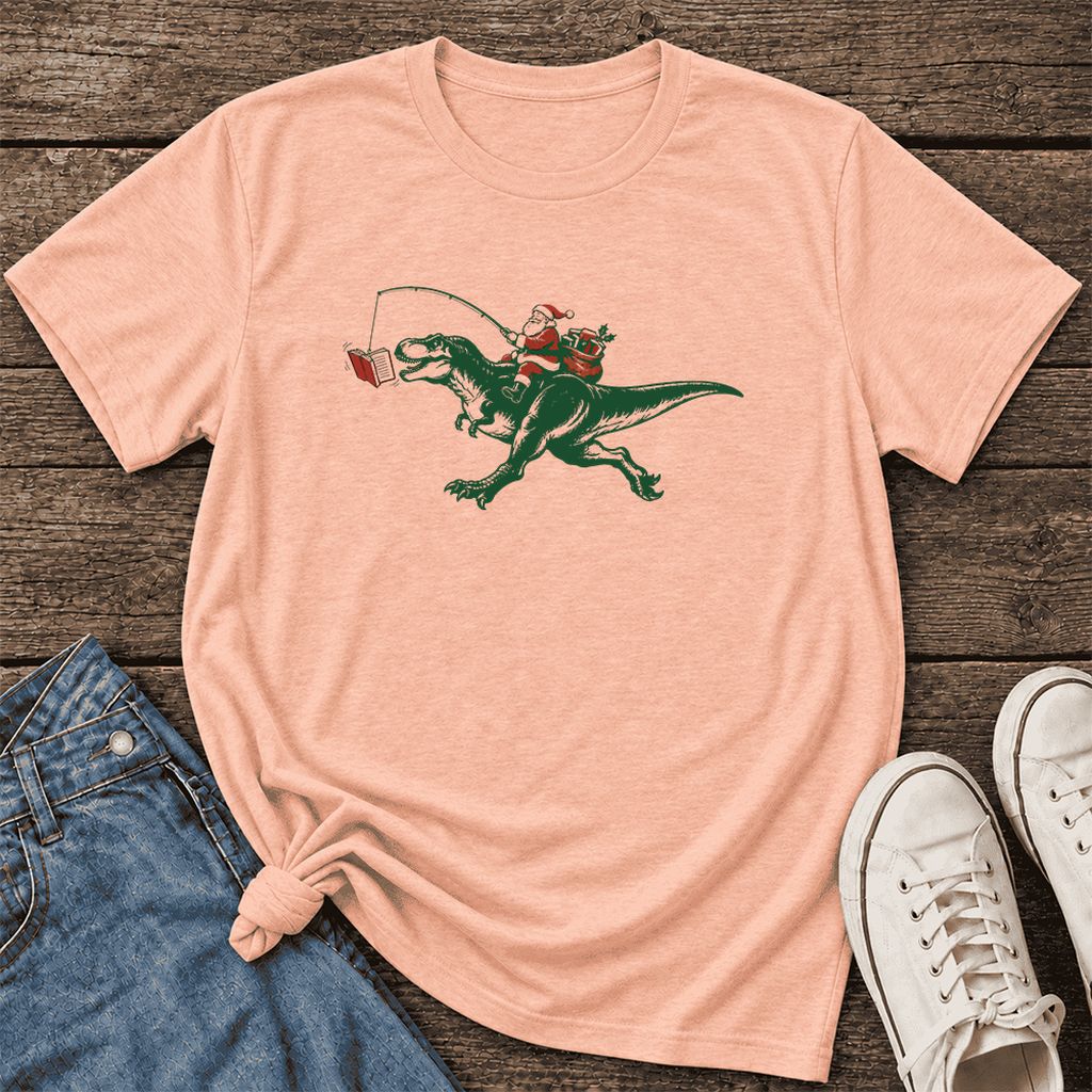 Santa Riding T-Rex Ultra-Soft Cotton T-Shirt | Christmas Reader Gift Heather Peach