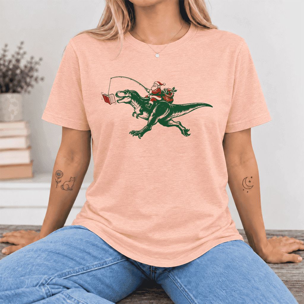 Santa Riding T-Rex Ultra-Soft Cotton T-Shirt | Christmas Reader Gift Heather Peach