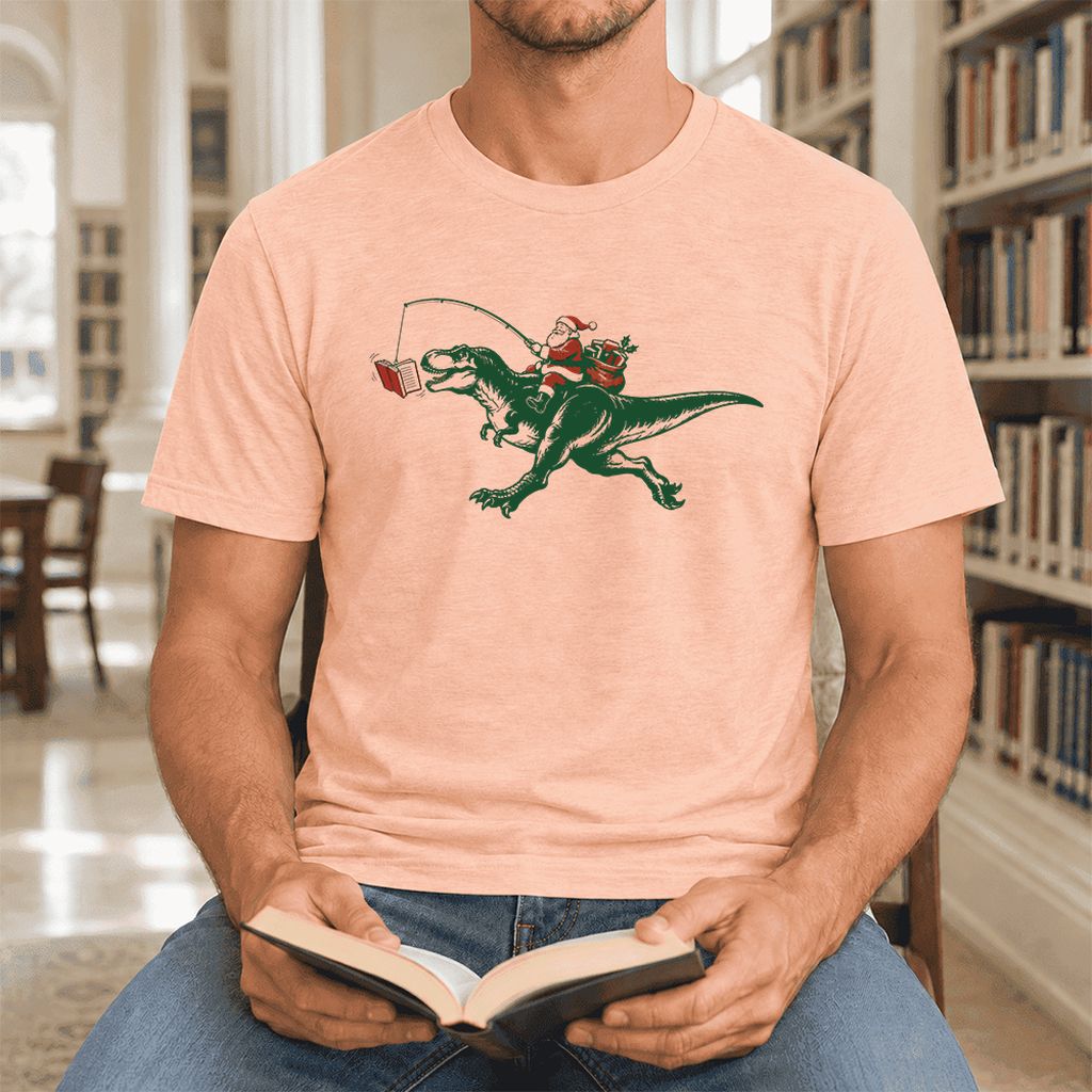 Santa Riding T-Rex Ultra-Soft Cotton T-Shirt | Christmas Reader Gift Heather Peach