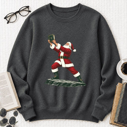 Santa Claus Holding Up A Green Book Printed Sweatshirt | Christmas Gift Dark Heather