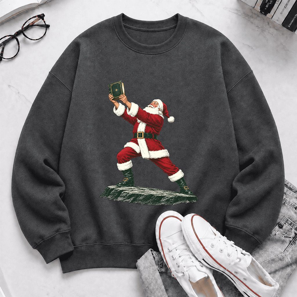 Santa Claus Holding Up A Green Book Printed Sweatshirt | Christmas Gift Dark Heather