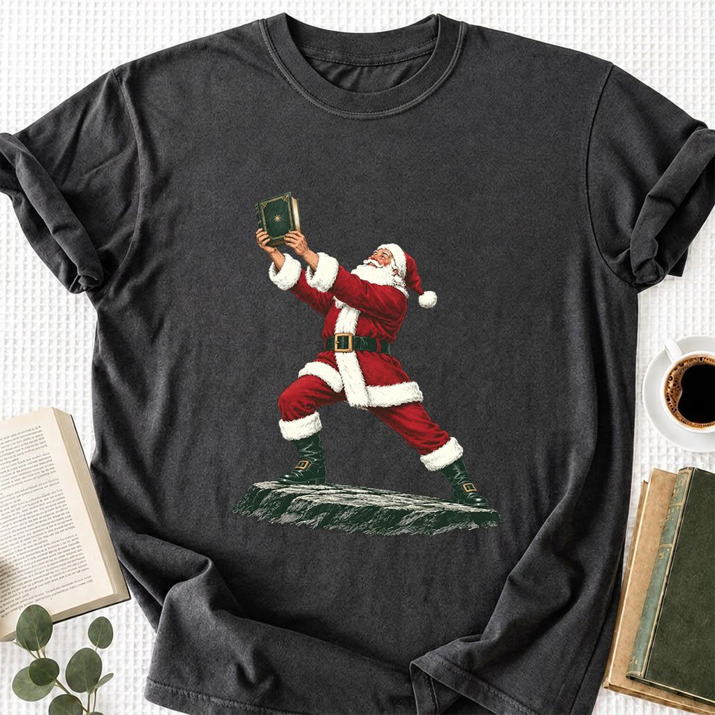 Santa Claus Holding Up A Green Book Printed T-Shirt | Christmas Gift Dark Heather