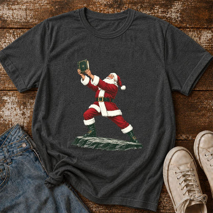 Santa Claus Holding Up A Green Book Printed T-Shirt | Christmas Gift Dark Heather