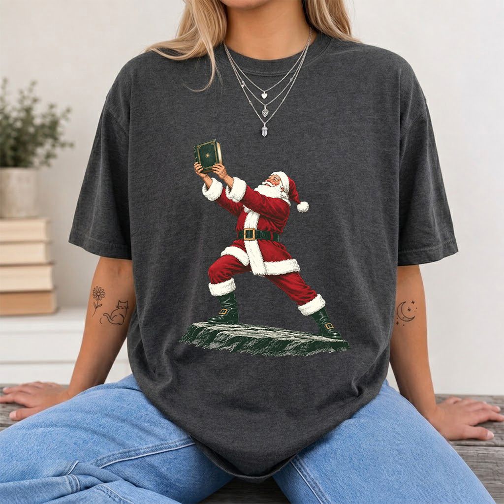 Santa Claus Holding Up A Green Book Printed T-Shirt | Christmas Gift Dark Heather