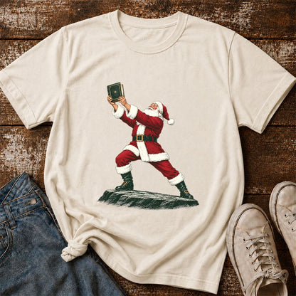 Santa Claus Holding Up A Green Book Printed T-Shirt | Christmas Gift Natural