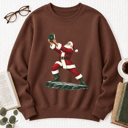 Santa Claus Holding Up A Green Book Softstyle Sweatshirt | Christmas Gift Cocoa