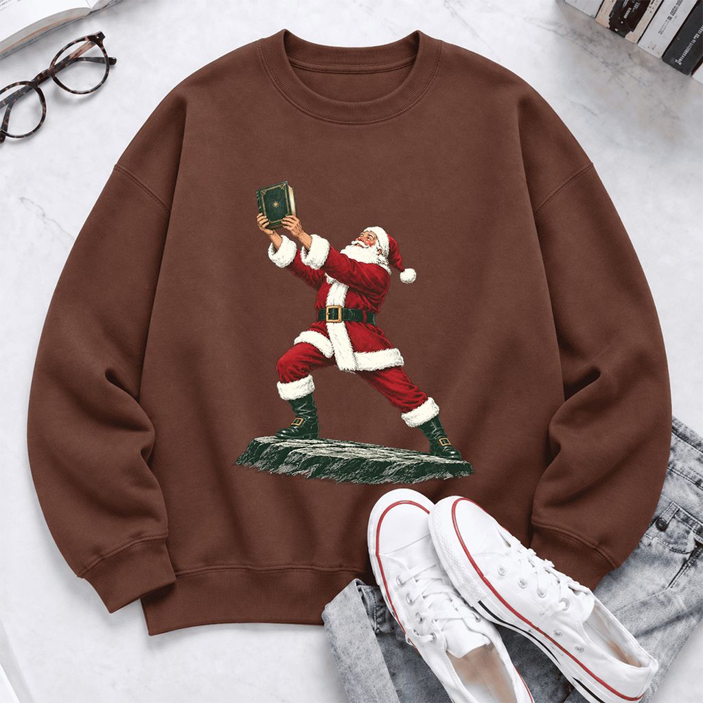Santa Claus Holding Up A Green Book Softstyle Sweatshirt | Christmas Gift Cocoa