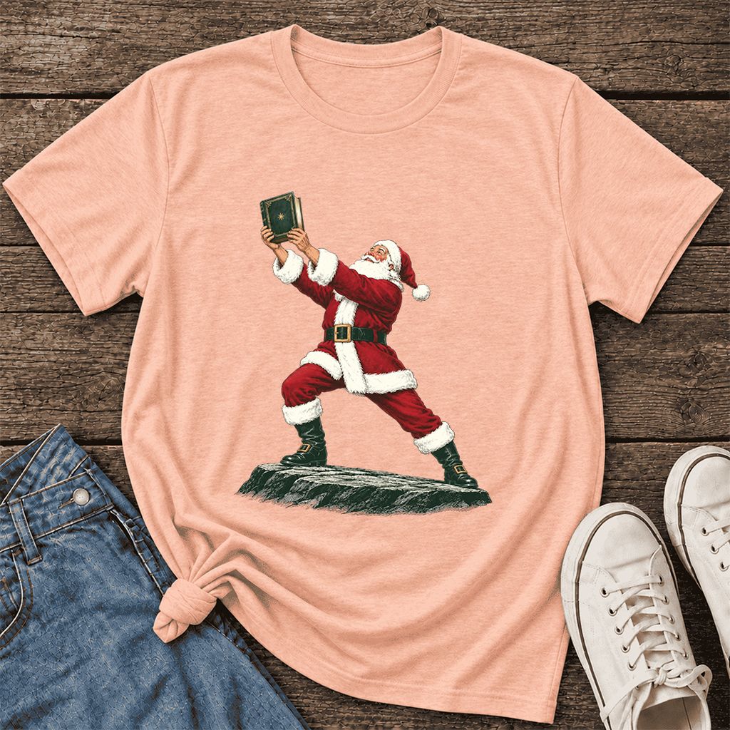 Santa Claus Holding Up A Green Book Ultra-Soft Cotton T-Shirt | Christmas Gift Heather Peach