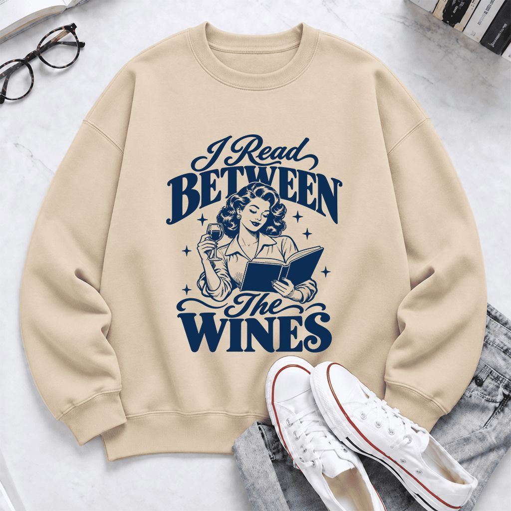 I Read Between The Wines Softstyle Sweatshirt | Cozy Book Lover Gift Sand