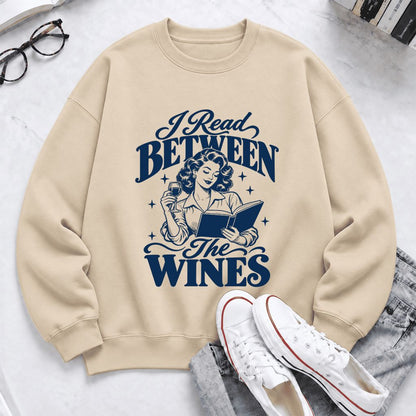I Read Between The Wines Softstyle Sweatshirt | Cozy Book Lover Gift Sand