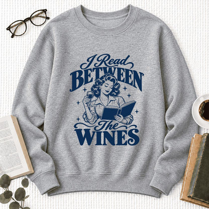 I Read Between The Wines Softstyle Sweatshirt | Cozy Book Lover Gift Sport Grey