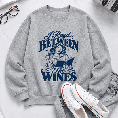 I Read Between The Wines Softstyle Sweatshirt | Cozy Book Lover Gift Sport Grey