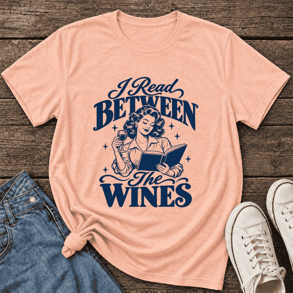 I Read Between The Wines Ultra-Soft Cotton T-Shirt | Cozy Book Lover Gift Heather Peach