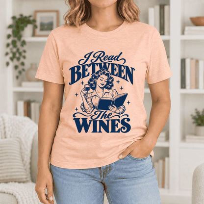 I Read Between The Wines Ultra-Soft Cotton T-Shirt | Cozy Book Lover Gift Heather Peach