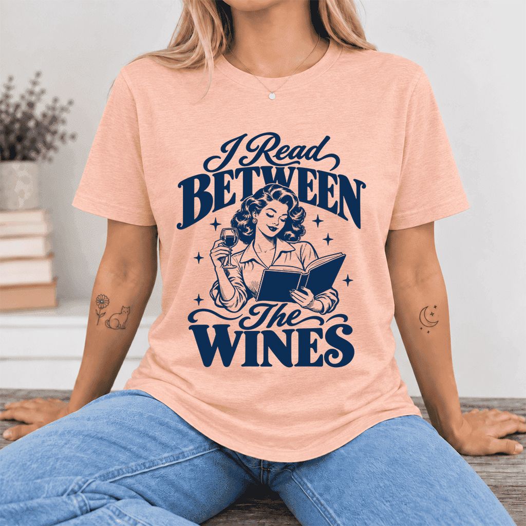 I Read Between The Wines Ultra-Soft Cotton T-Shirt | Cozy Book Lover Gift Heather Peach