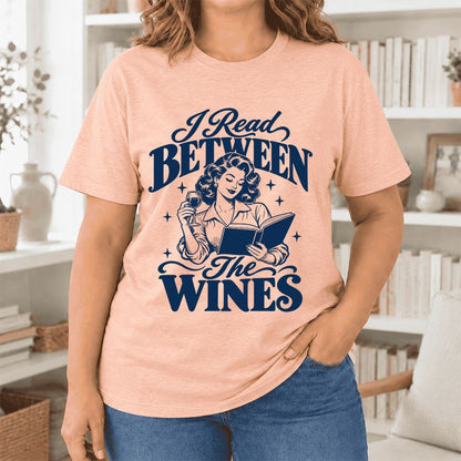 I Read Between The Wines Ultra-Soft Cotton T-Shirt | Cozy Book Lover Gift Heather Peach