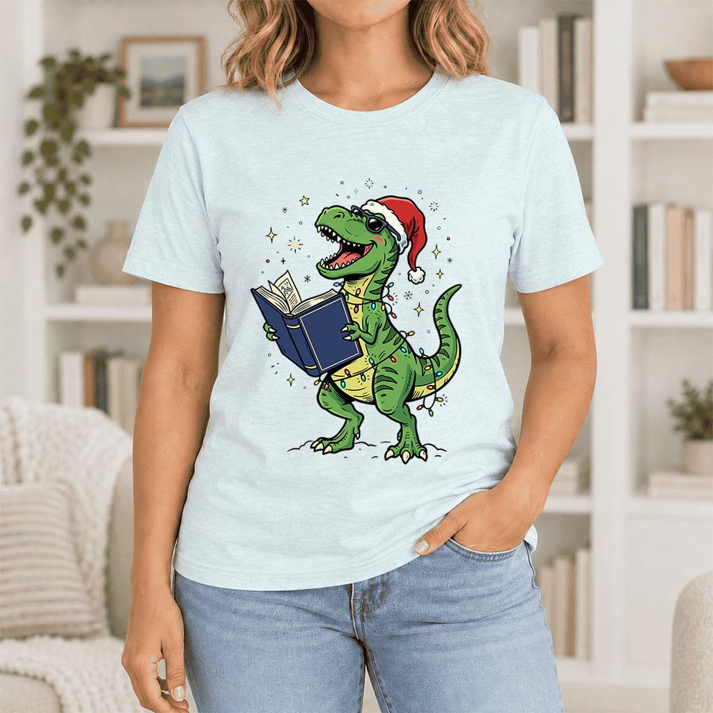 T-Rex Wearing Santa Hat And Reading Ultra-Soft Cotton T-Shirt | Christmas Gift Heather Ice Blue