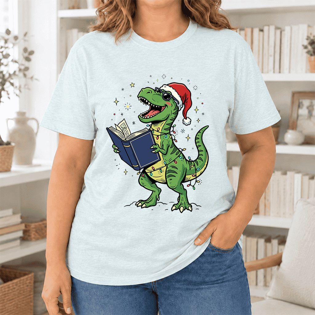T-Rex Wearing Santa Hat And Reading Ultra-Soft Cotton T-Shirt | Christmas Gift Heather Ice Blue