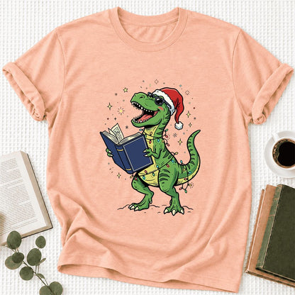 T-Rex Wearing Santa Hat And Reading Ultra-Soft Cotton T-Shirt | Christmas Gift Heather Peach