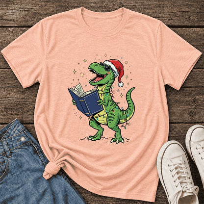 T-Rex Wearing Santa Hat And Reading Ultra-Soft Cotton T-Shirt | Christmas Gift Heather Peach