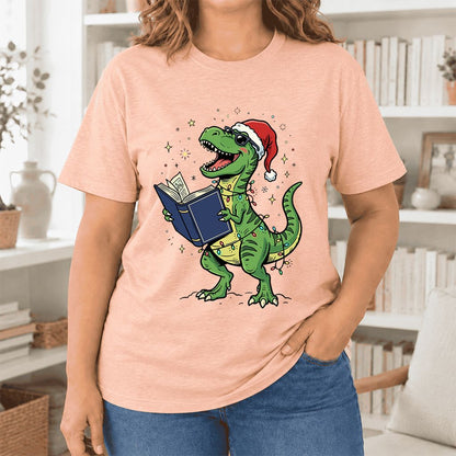 T-Rex Wearing Santa Hat And Reading Ultra-Soft Cotton T-Shirt | Christmas Gift Heather Peach