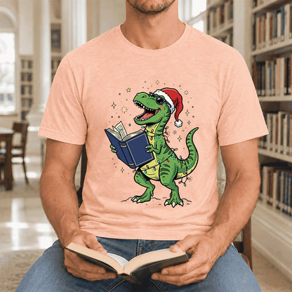 T-Rex Wearing Santa Hat And Reading Ultra-Soft Cotton T-Shirt | Christmas Gift Heather Peach