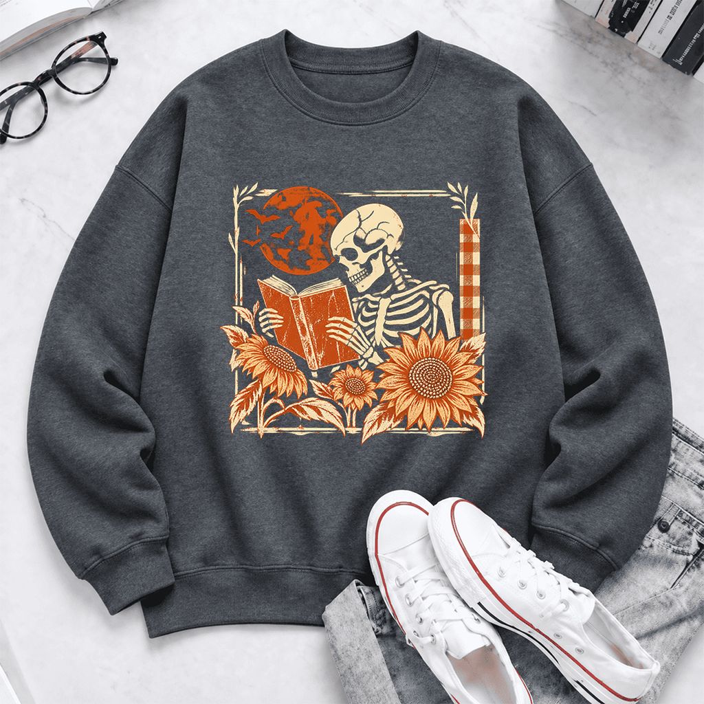 Skeleton Reading Sunflowers Softstyle Sweatshirt | Halloween Book Lover Gift Dark Heather