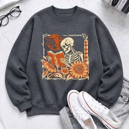 Skeleton Reading Sunflowers Softstyle Sweatshirt | Halloween Book Lover Gift Dark Heather